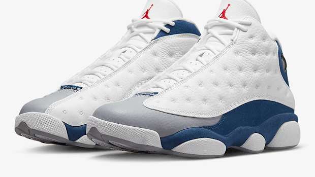 White and blue Air Jordan 13 shoes.